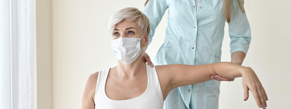 physiotherapist-undergoing-therapy-with-female-patient